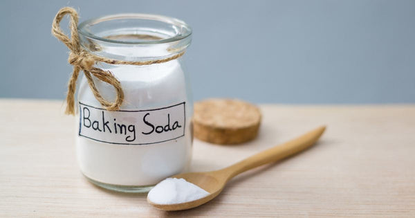 Baking soda in a small jar with a wooden spoon