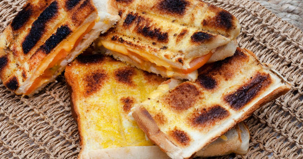 Campfire grilled cheese, onion, tomatoes, and chutney sandwiches