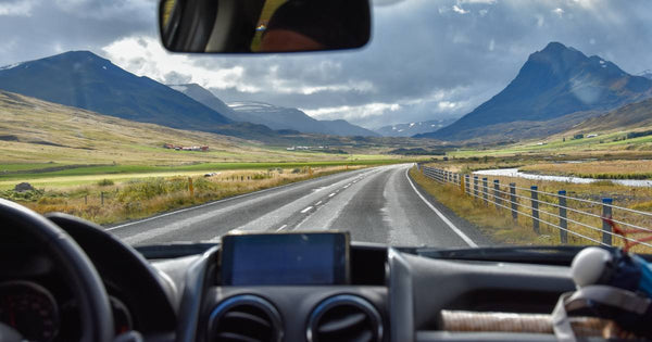car driving on a road trip with mountain views