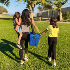 Mother walking with her two daughters carrying a teal Viva Cubix rotomolded cooler