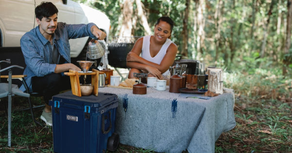 People using a Cubix cooler while camping outdoors