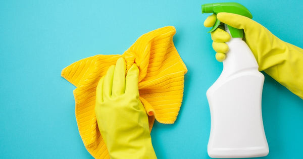 Person wearing yellow gloves cleaning