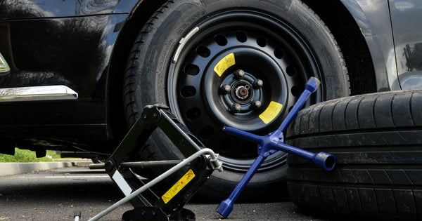 Replacing a spare tire on a road trip