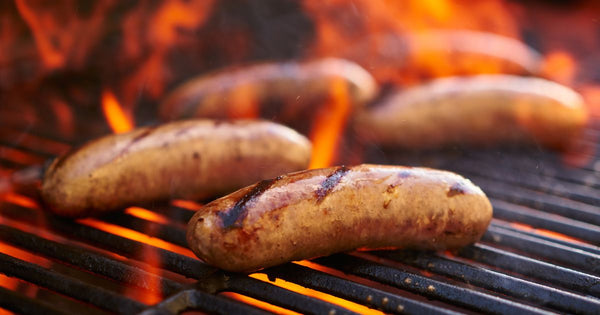 sausage cooking on a fire